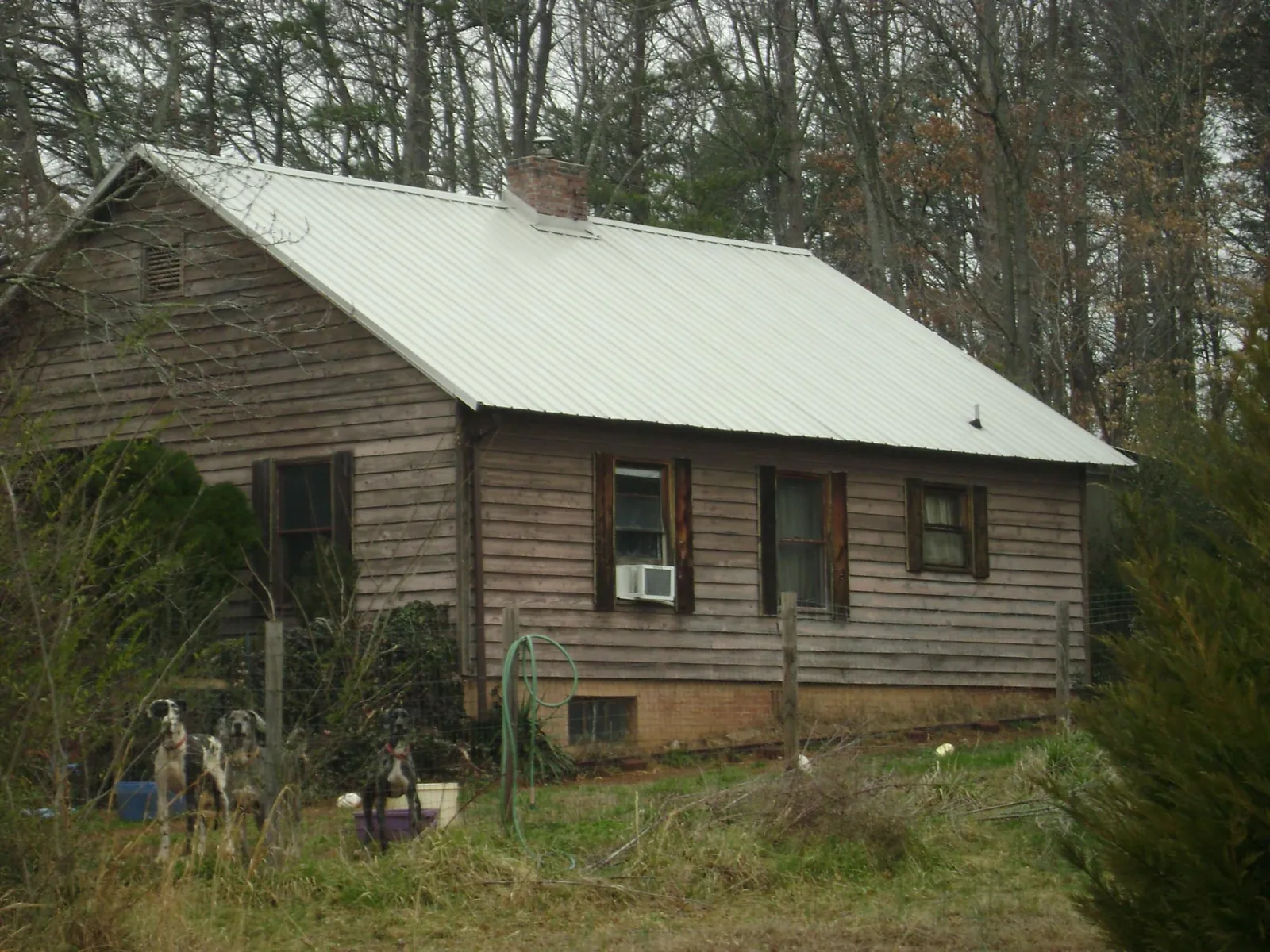 White metal roof on an old wood sided farmhouse, from a Metal Roof Installation job in New Hyde Park